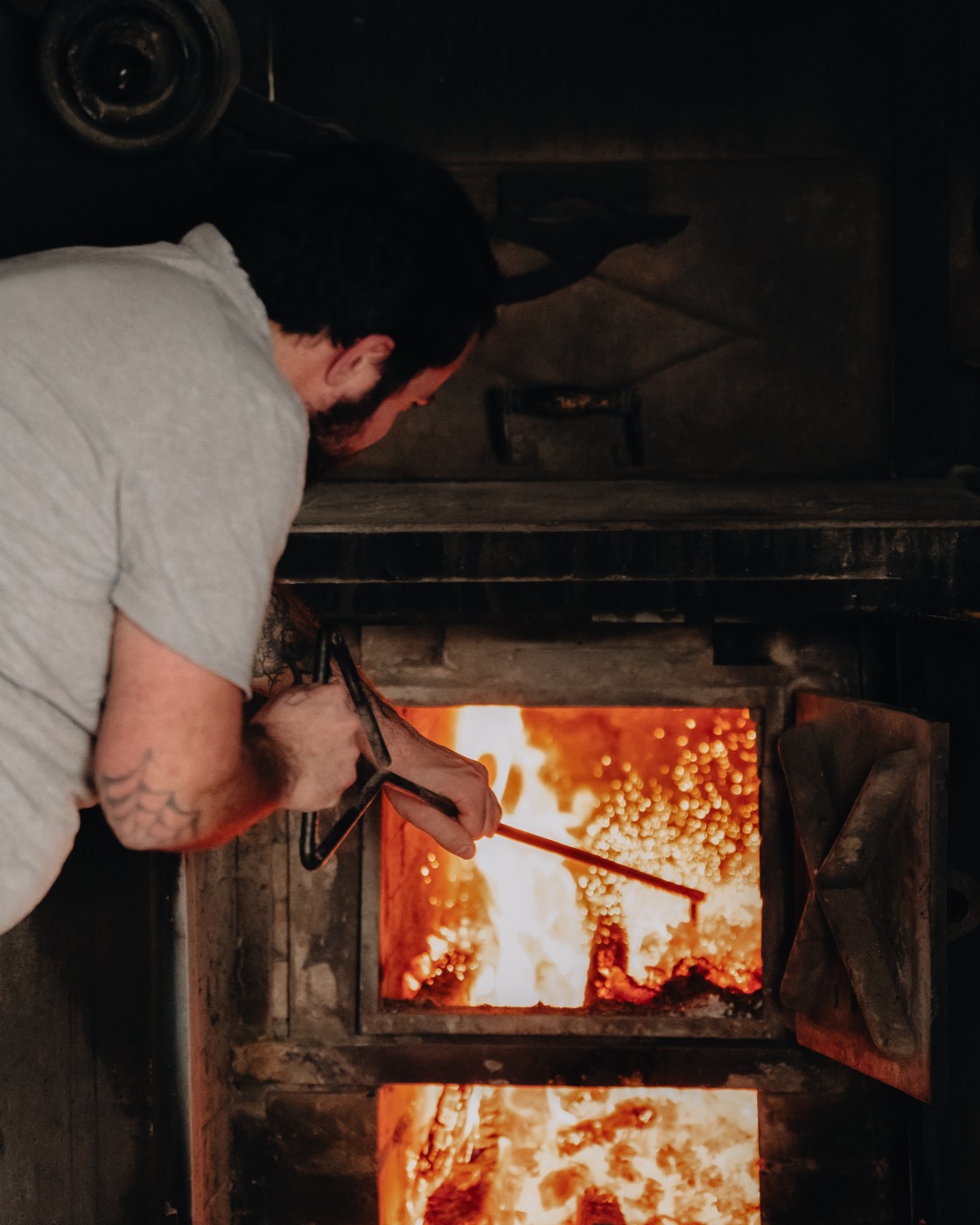 Loïc, boulanger, penché sur son four à bois en flammes, à vingt minutes de Souki dans l'Hérault