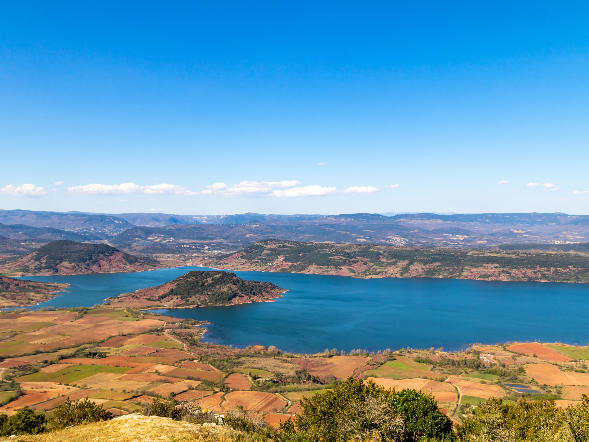 Lac du Salagou seen from above, its red-earth shores and hills to the horizon