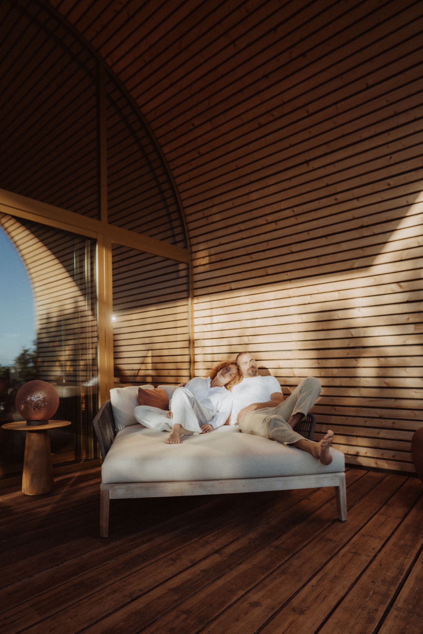 Couple lying on the bench of a terrace, shadow play, Souki Lodges & Spa