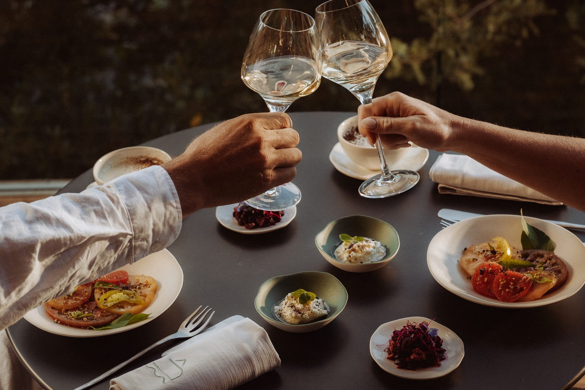 Clink a glass of white wine during a gourmet dinner at Souki Lodges & Spa