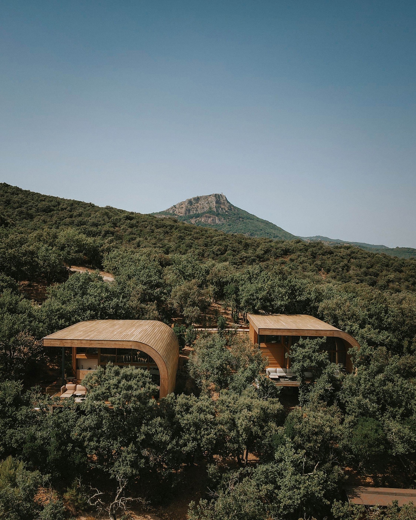 The two Souki lodges nestled in the oaks, the Pic de Vissou rising behind them